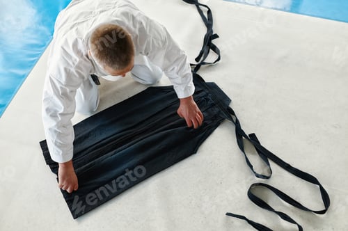 Preview: Aikido sensei folding kimono hakama after training class