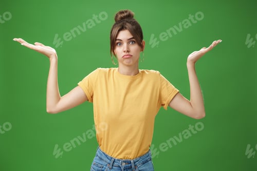 Preview: Girl do not know anything. Portrait of confused unsure cute woman with combed hair shrugging with