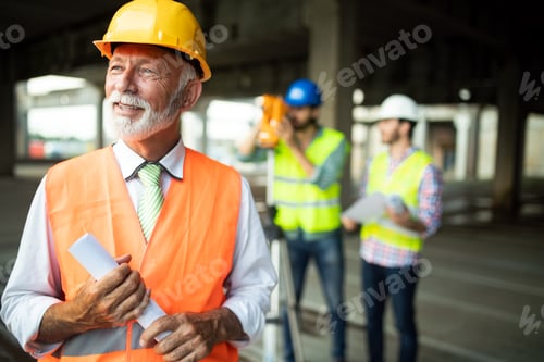 Preview: Confident team of architects and engineers working together on construction site