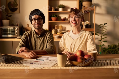 Preview: Smiling Professional Colleagues Working at Office Table