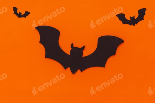Preview: Bats on orange background. Happy Halloween element for design