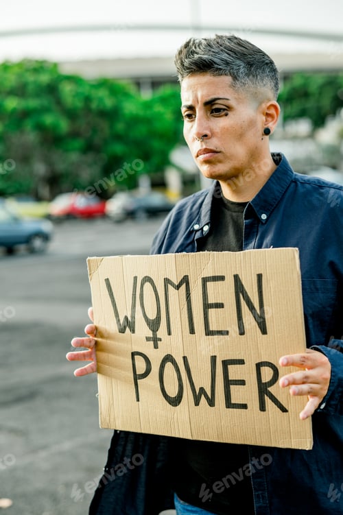 Preview: Woman in casual clothes with placard protesting on street