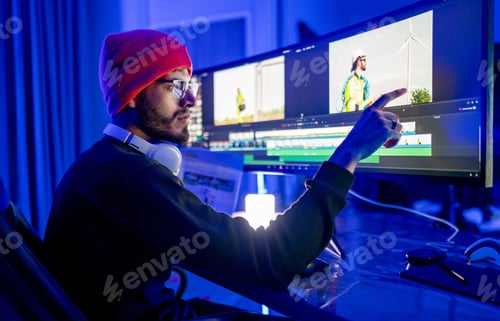 Preview: Editor working with computer at home with RGB ambient light.