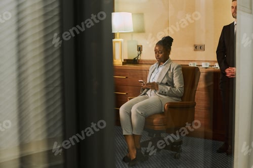 Preview: Financial director texting in smartphone