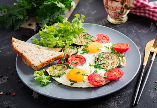 Preview: English breakfast - fried eggs, tomatoes and eggplant. American food.