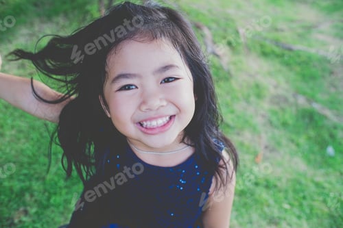 Preview: Smiling Girl with Dark Hair Posing Outdoors