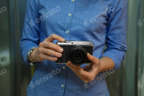 Preview: Soft focus photo of female hands with retro style camera
