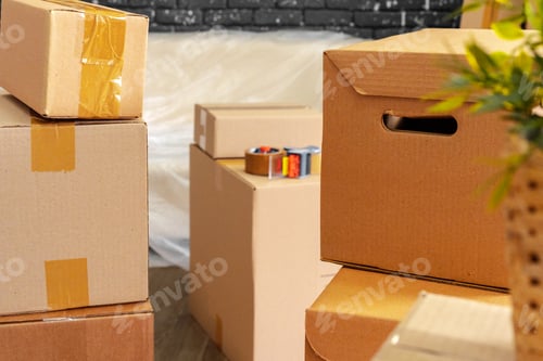 Preview: Moving in or moving out concept. Stack of boxes and packed furniture