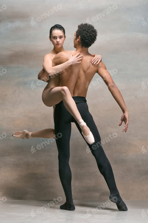 Preview: Couple of ballet dancers posing over gray background