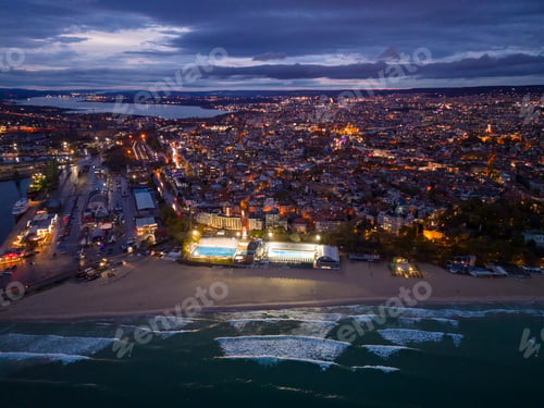 Preview: Aerial view of Varna city port at sunset. Night urban landscape.