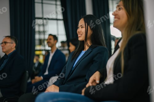 Preview: Attendees Listening to Presentation During Conference Indoors