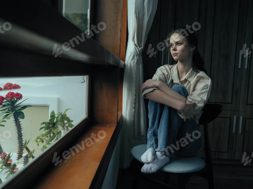 Preview: Woman fall depression sitting by the window and looking at nature, rainy weather and discouragement