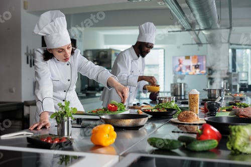 Preview: Head chef cooking food for dinner service while adding ingredients to meal.