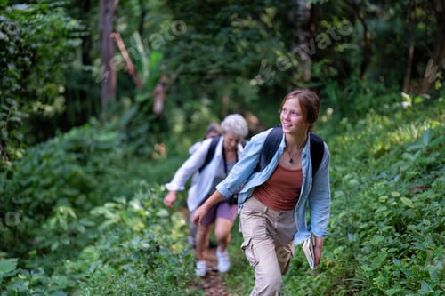 Preview: Backpack adventure hiking traveler walking up to mountain hill on the greenery tree nature park
