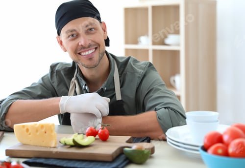 Preview: Professional chef in uniform working at restaurant kitchen