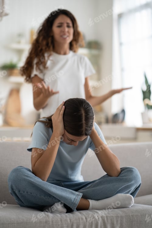 Preview: Naughty girl closing ears looks down sits on couch refusing to fulfill aggressive mother requests