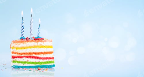 Preview: Birthday cake with burning candles on a blue