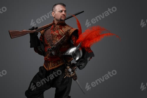 Preview: Stylish musketeer dressed in red costume holding rifle
