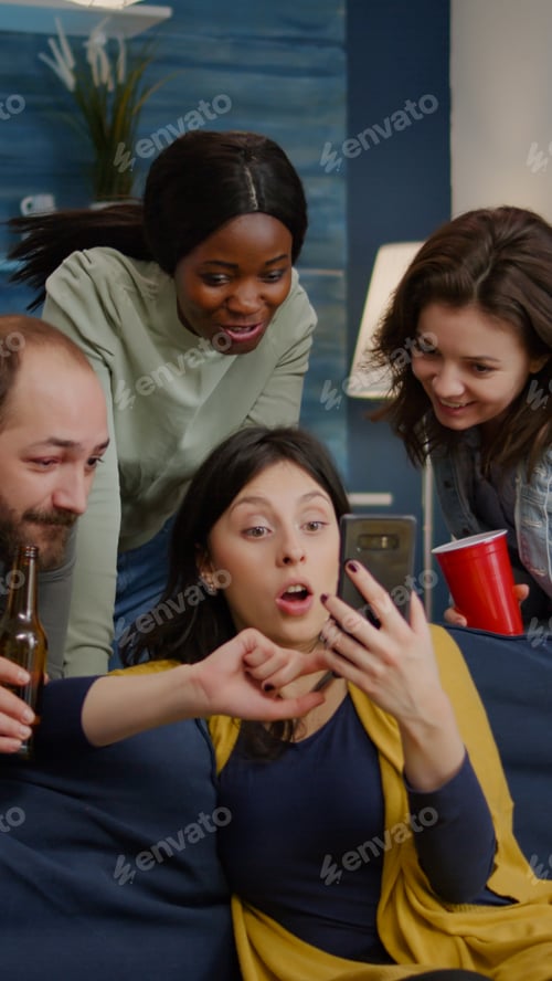 Preview: Multiracial friends hanging out late at night watching funny entertainment video