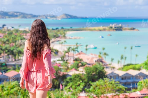 Preview: Young tourist woman with view of bay at tropical island in the Caribbean Sea
