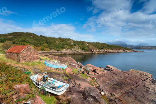 Preview: Old boats and a croft with a rusty tin roof on the shore at Kenm