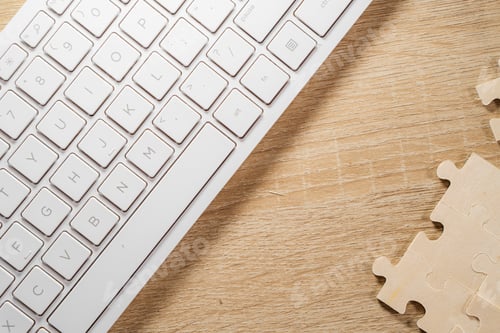 Preview: White jigsaw puzzle with piece on wooden background
