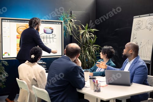Preview: Team of business employees examining statistics and infographics
