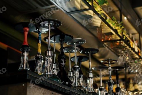 Preview: close-up of various hookahs with smoking equipment shelves in lounge bar flasks pipes bowls
