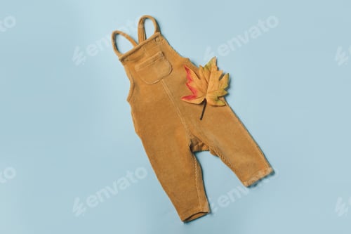 Preview: Mustard baby romper, yellow autumn leaves on blue background. Set of baby clothes