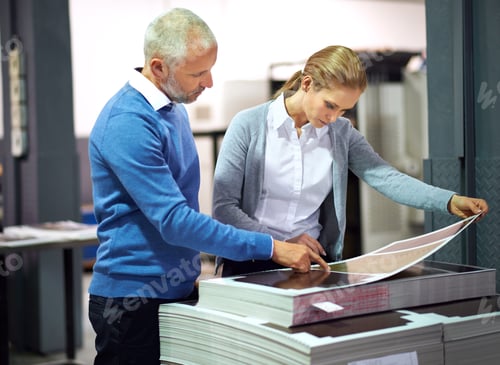 Preview: This is good work...Two publishers assessing the quality of printed work in a factory.