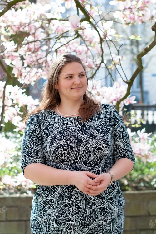 Preview: Portrait of a beautiful plump caucasian confident woman in magnolia flowers
