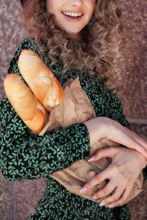 Preview: A young French woman with French baguettes outdoors