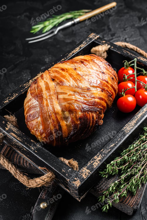 Preview: Roast bacon wrapped meatloaf, meat loaf in a tray with herbs. Black background. Top view