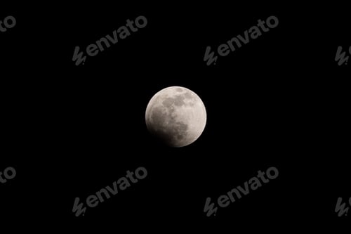 Preview: Lunar eclipse full crescent super moon rising against the dark sky