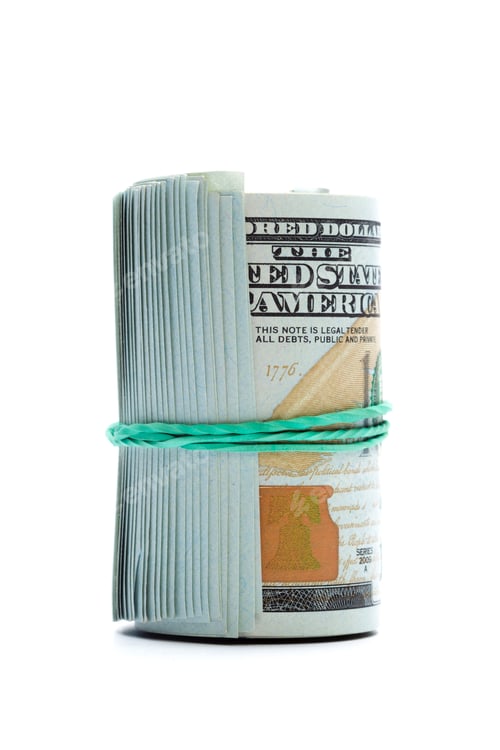 Preview: Stack of cash wrapped with a rubber band on a clean white background