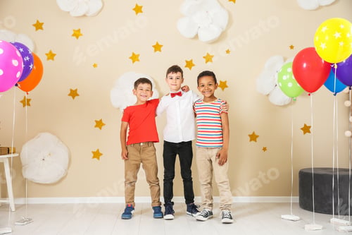 Preview: Adorable little boys at birthday party indoors