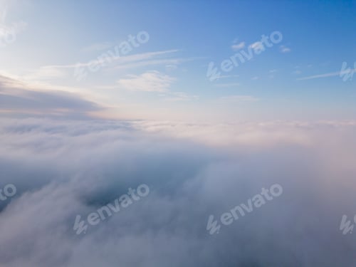 Preview: A drone flies over fluffy clouds. The drone flies through the clouds, creating a sense of wonder