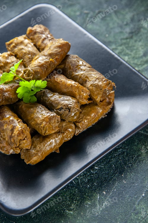 Preview: front view tasty leaf dolma with ground meat inside plate on dark blue background restaurant dish