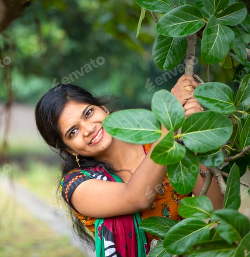 Preview: Beautiful girl between nature full of branches of tree.