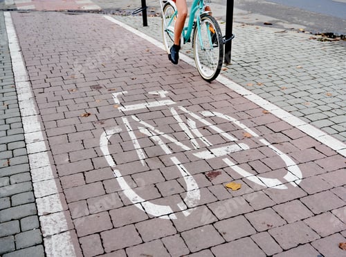 Preview: Woman riding on bicycle path in centre city.