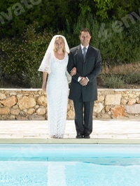 Preview: Bride and groom by edge of swimming pool