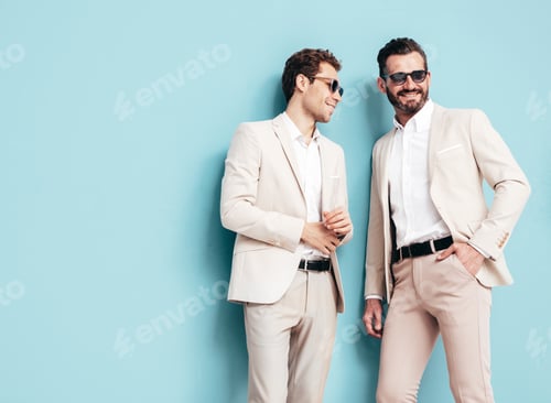 Preview: Two handsome men in suit posing in studio