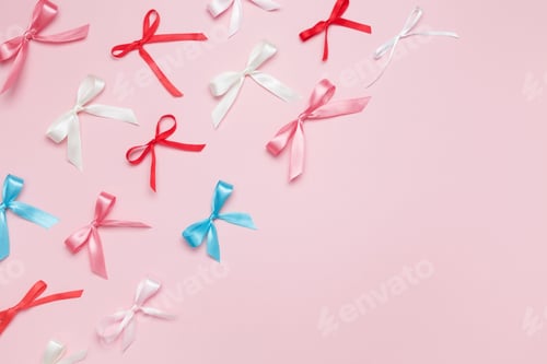 Preview: Multicolored bows on pink background. Top view, copy space