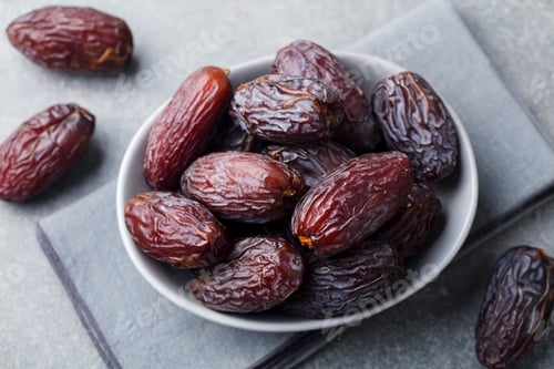 Preview: Fresh medjool Dates in Bowl. Grey Background. Close up.