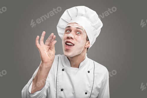 Preview: Crazy young male baker with flour on face gesturing at camera