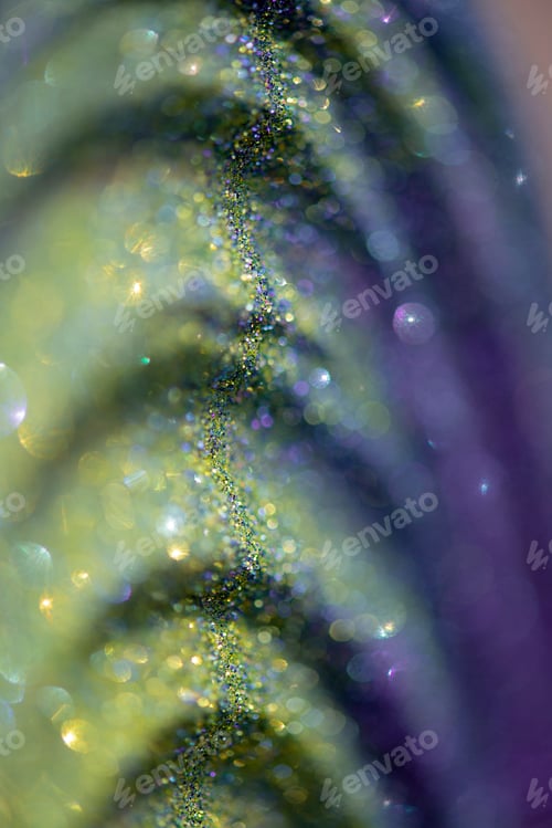 Preview: Abstract glitter lights colorful bokeh background in purple,gold and yellow color tones