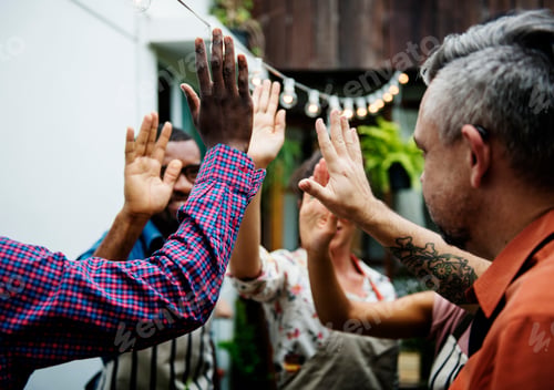 Preview: Group of diverse people with hands raised teamwork