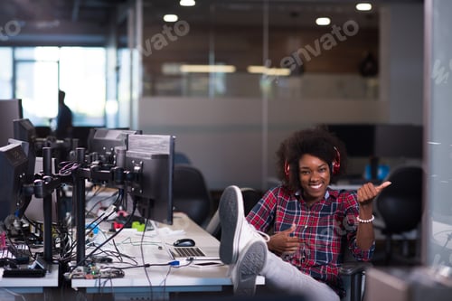 Preview: woman at her workplace in startup business office listening musi