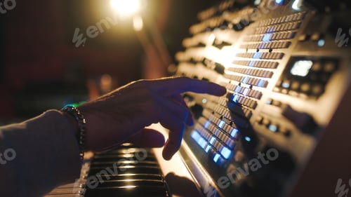 Preview: Hands of a man sound engineer are pressing buttons on the console