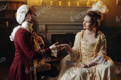 Preview: Caucasian Young Adult Man Kneeling before Caucasian Young Adult Woman Indoors